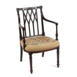 A George III style mahogany carver or desk chair with carved back rail, fluted arms on vase column