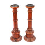 A pair of 19th century fruitwood floor standing pricket or candlesticks with tapering ring turned
