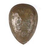 A bronzed composite shield decorated with warriors on horseback and mythical beasts, 43 by 59cms.