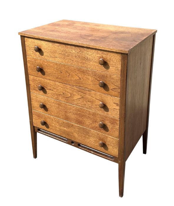 A mid 20th century teak chest in the manner of Heal's with an arrangement of five long drawers, on