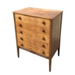 A mid 20th century teak chest in the manner of Heal's with an arrangement of five long drawers, on