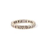 A 9ct white gold and spinel eternity ring, approx UK size 'M'.