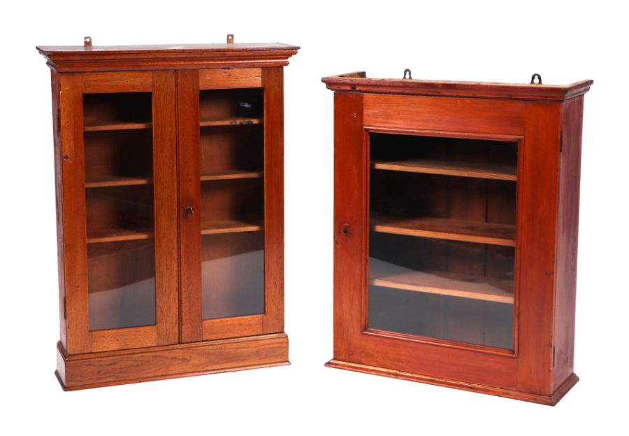 An Edwardian mahogany wall hanging display cabinet, the twin glazed doors enclosing a shelved