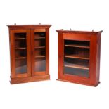 An Edwardian mahogany wall hanging display cabinet, the twin glazed doors enclosing a shelved