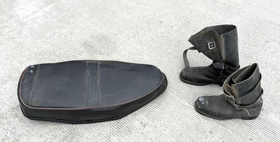 A BSA ZB Gold Star saddle; together with a pair of black leather motorcycle boots.