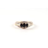 A 9ct gold three-stone sapphire ring, approx UK size 'P', 1.9g.