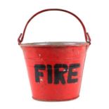A red painted galvanised fire bucket.