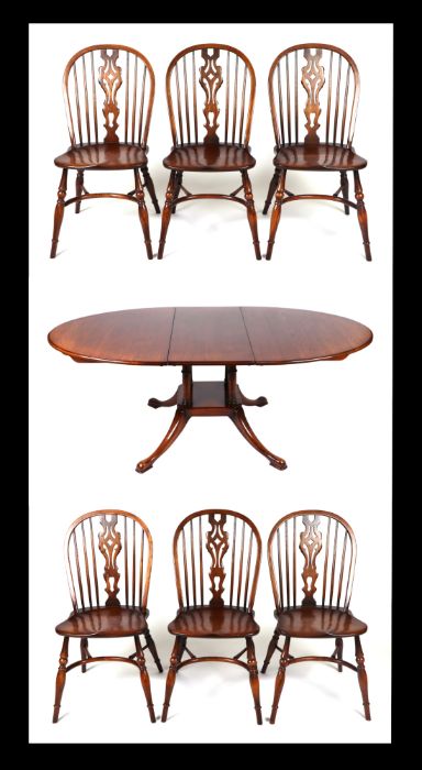 A set of six oak wheelback dining chairs with crinoline stretchers; together with an oak oval