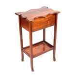 An Edwardian mahogany work table with shaped rectangular top and under tier, 46cms wide.