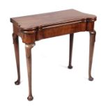 A George III mahogany card table on turned legs terminating in pad feet, 84cms wide.Condition