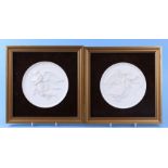 A matched pair of Royal Copenhagen bisque porcelain plaques decorated with angels and cherubs, 15cms