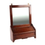 An Edwardian oak wall mirror with candle box beneath, 33cms wide.
