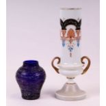 A continental milk glass two-handled vase decorated with swags, 37cms high; together with a Kralik