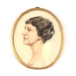 An early 20th century portrait miniature depicting a lady wearing ruby earrings, painted on ivorine,