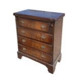 A reproduction mahogany chest with fold-over top above four long drawers, 64cms wide.