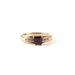 A 9ct gold emerald cut garnet solitaire ring, approx UK size 'N', 2.7g.