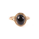 A 9ct gold dress ring set with a smoky quartz cabochon, approx UK size 'M', 1.6g.