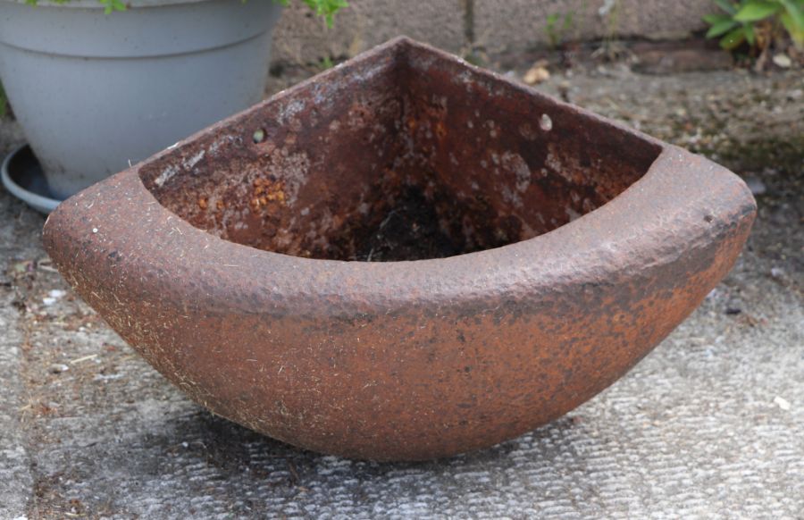 A cast iron corner feeder / planter, 65cms wide.