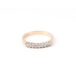 A 9ct gold ring set with nine small diamonds, approx UK size 'L', 1.9g.