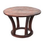 An Assam table carved from a single piece of wood, 85cms diameter.