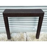 A modern leather console table with studwork decoration, 92cms wide.