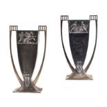 A large pair of Art Deco silver plated vases with elongated handles and embossed Roman scenes, 31cms