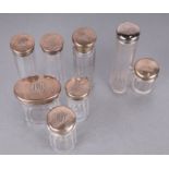 A set of six George V silver topped glass cosmetics jars, initialled, London 1919 and other