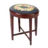 An oval mahogany stool with upholstered seat, 44cms wide.