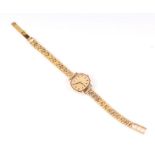 A 9ct gold ladies Longines bracelet watch, the champagne dial with baton indices and fitted with