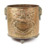 A large brass log bin decorated in relief with the family crest of John Lord of Bletso, 39cms