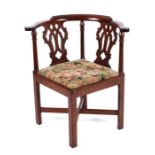 A Late Victorian / Edwardian walnut corner chair with twin pierced back splats, drop-in seat and