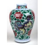 A Chinese famille verte baluster vase decorated with shishi and prunus, 19cms highCondition