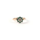 A 9ct gold diamond and emerald flower head cluster ring, approx UK size 'K', 1.8g.