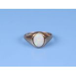 A 9ct gold ring set with an oval opal cabochon, approx UK size 'I', 1.2g.