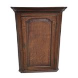 A 19th century oak corner cupboard with shelved interior, 78cms wide.