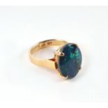 A 14ct gold and black opal cabochon ring, approx UK size 'K', 4.8g.