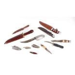 A quantity of assorted sheath and pocket knives to include a carved wooden scabbard example, 34cms