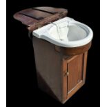 A late 19th century mahogany vanity unit with lift-up top enclosing a ceramic sink and cupboard