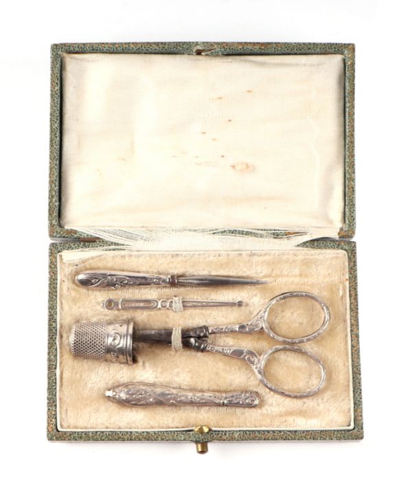 A late 19th / early 20th century continental white metal five piece etui or sewing kit in a fitted