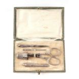 A late 19th / early 20th century continental white metal five piece etui or sewing kit in a fitted