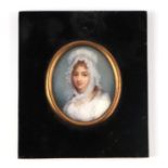 A portrait miniature on ivory depicting a young girl wearing a bonnet, framed & glazed, the