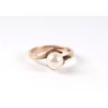 A 9ct gold and solitaire pearl ring in an open cross-over hands setting, approx UK size 'I', 2g.