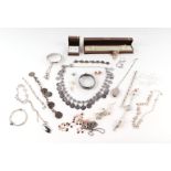 A quantity of assorted costume jewellery to include bangles, necklaces, lockets and similar items,