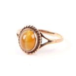 A 9ct gold dress ring set with an oval tiger's eye cabochon, approx UK size 'O', 2.3g.