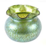 A Loetz style glass bowl with pinched rim and peacock iridescent finish, 14cms diameter.