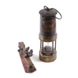A Thomas & Williams of Aberdare Navy type miner's lamp, 25cms high; together with a brass door