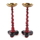 A pair of painted barley twist stands with brass pans, 30cms high (2).