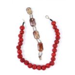 A hardstone panel and silver bracelet, 20cms long; together with a coral type bead necklace,