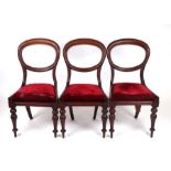 Three Victorian mahogany balloon back dining chairs with drop-in seats (3).