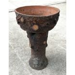 A large terracotta planter in the form of a tree stump, 94cm high, 56cm diameter